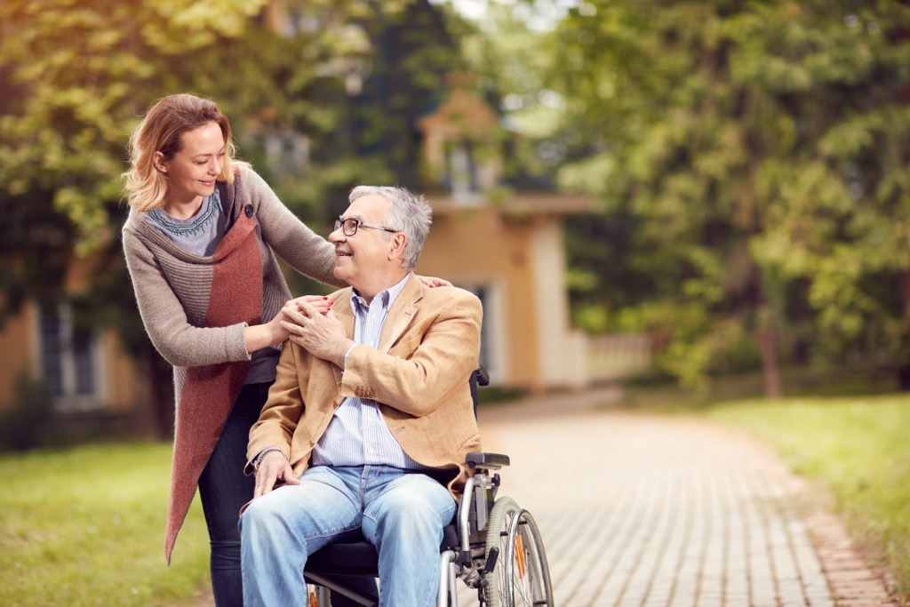 A social worker walks alongside a client outside a supportive housing residence
